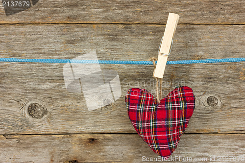 Image of Heart hang  over a wooden background