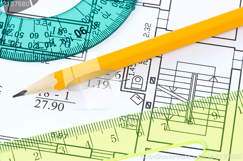 Image of  rulers and pencil on architectural  blueprint 