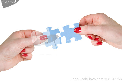 Image of  hands with different pieces of puzzle