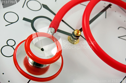 Image of  red stethoscope on the clock