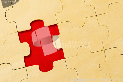 Image of wooden puzzle  with one piece missing