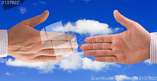 Image of Handshake on sky background