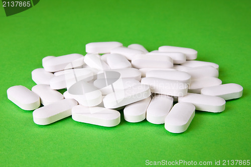 Image of medical pills on the green background