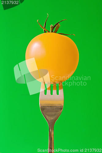 Image of fork with yellow tomato