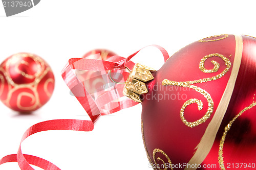 Image of red baubles over white