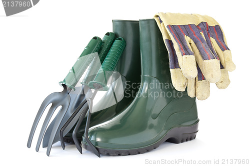 Image of  rubber boots with garden tools