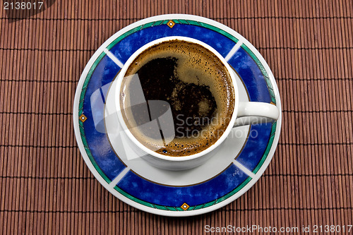 Image of coffee cup on bamboo tablecloth