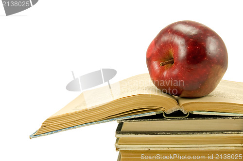 Image of red apple on the open book