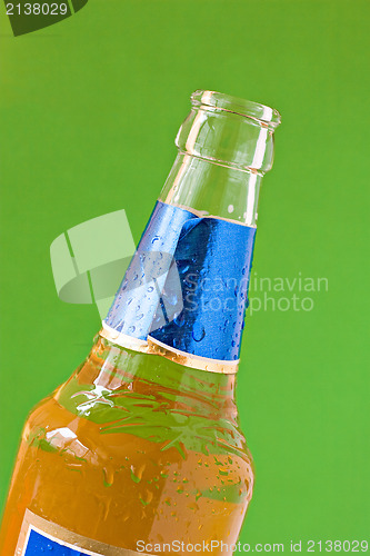 Image of beer bottle isolated on green background