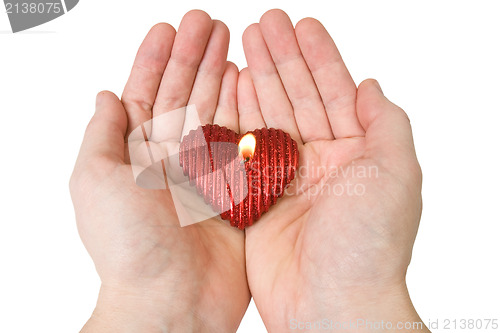 Image of  Heart-shape candle in a hands