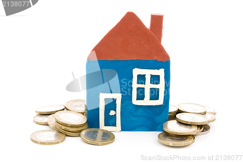 Image of house and coins over a white background