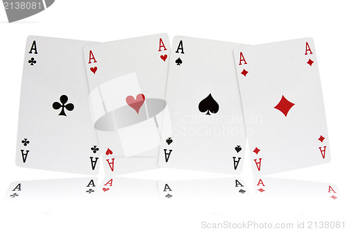 Image of four aces with reflection on white