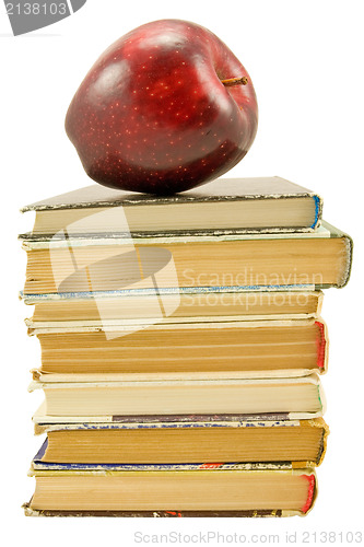 Image of books with red apple over white