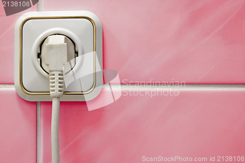 Image of white outlet on a red wall
