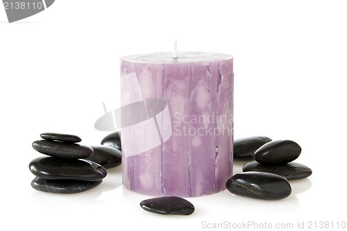 Image of aromatic candle and black pebbles