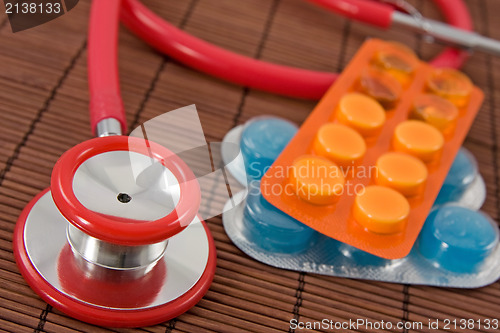 Image of  pills and red stethoscope