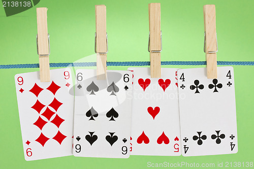 Image of playing cards hung on clothesline