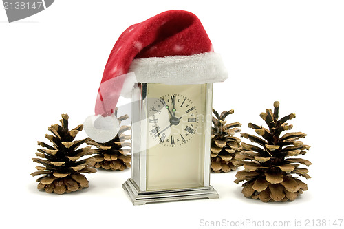 Image of clock with Santa hat and pine cones