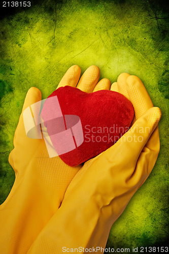 Image of hands with heart on green background