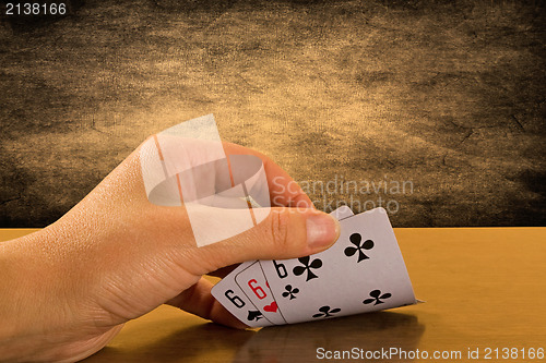 Image of  Player hand revealing triple six