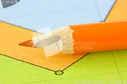 Image of orange pencil on the colorful paper
