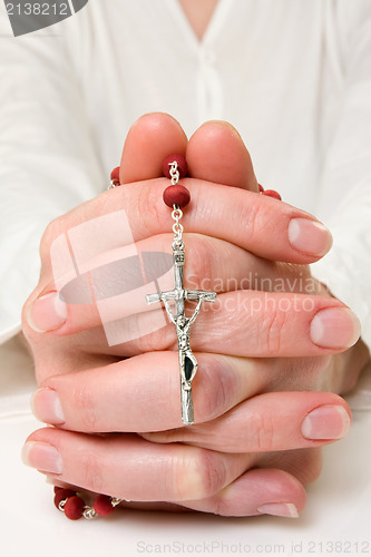 Image of female praying with rosary