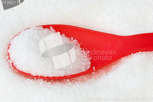 Image of red spoon with sugar