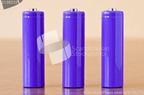 Image of three purple alkaline batteries