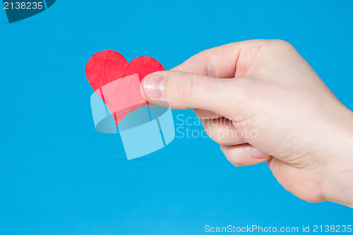 Image of Hand with heart on blue background