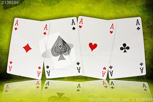 Image of four aces  on green background