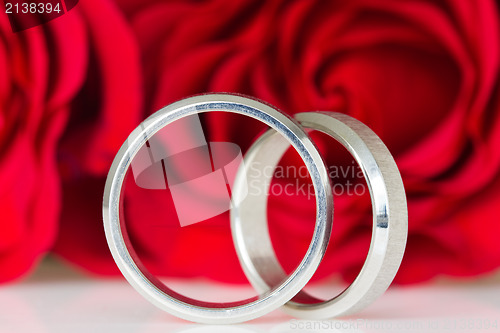 Image of two silver rings with red roses