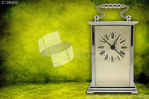 Image of clock on green dirty background