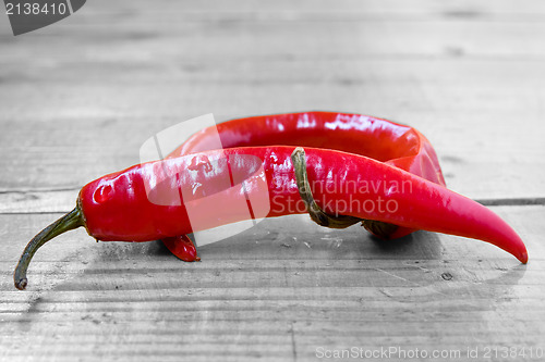 Image of Chili peppers on the wooden floor