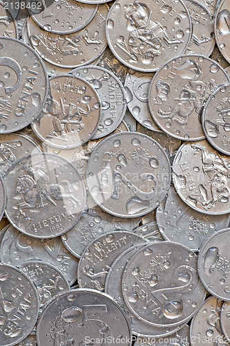 Image of wet silver coins