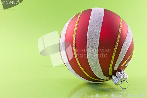 Image of christmas bauble on green background