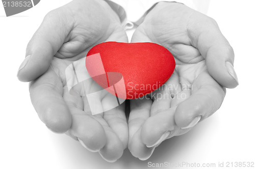Image of female hands holding red heart