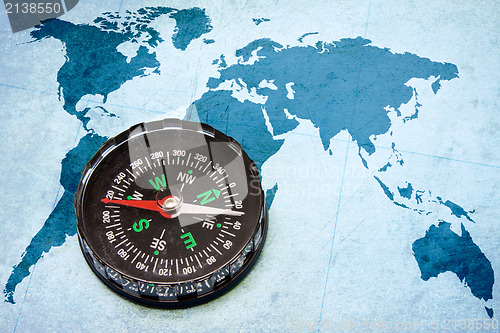 Image of compass on the blue world map