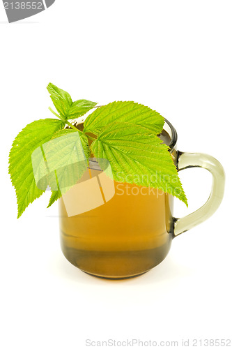 Image of cup with tea and green leaves