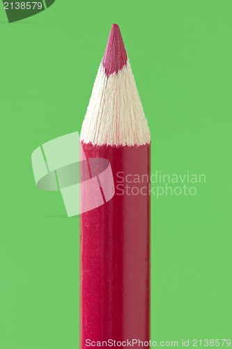 Image of red  pencil  over a green background