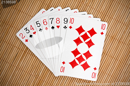 Image of playing cards on bamboo background