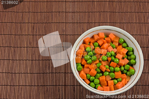 Image of bowl with green peas and carrots