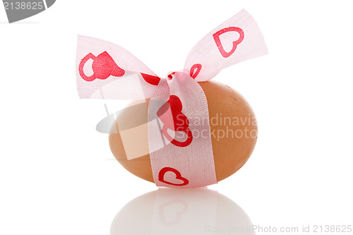 Image of brown egg with a ribbon