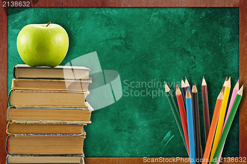 Image of books with apple and pencils