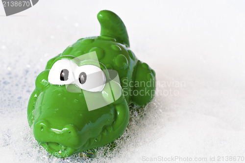 Image of funny crocodile in a bath foam