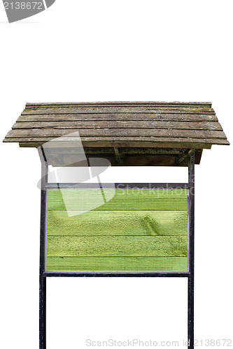 Image of Green wooden billboard with old roof
