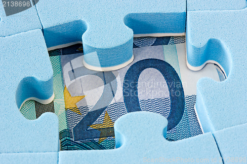 Image of Blue puzzle on Euro currency