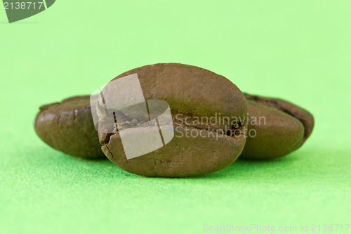 Image of coffee beans over a green background