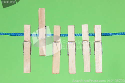 Image of Clothes pegs  on the green background