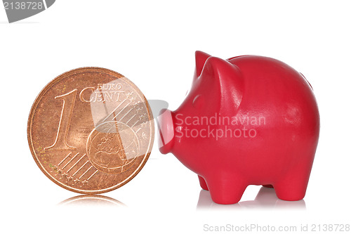 Image of Piggy bank and one eurocent 