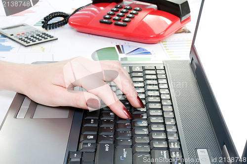 Image of  hand typing on computer keyboard